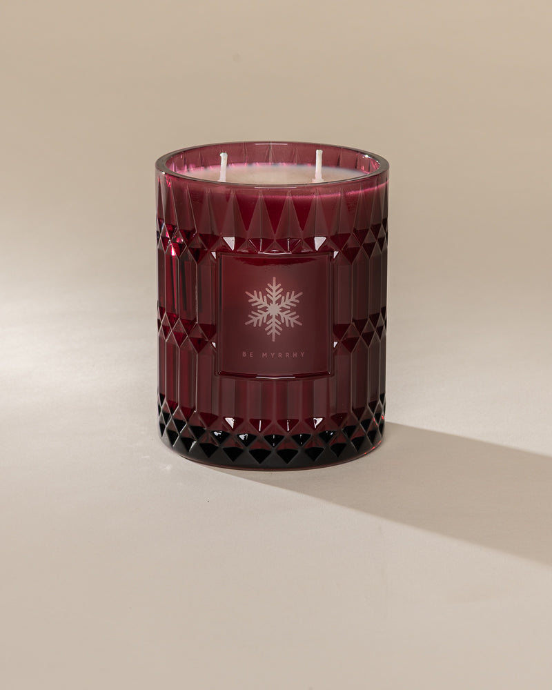 Poured New York 'Be Myrrhy' 22 oz red glass vintage etched coconut soy wax candle on a neutral background