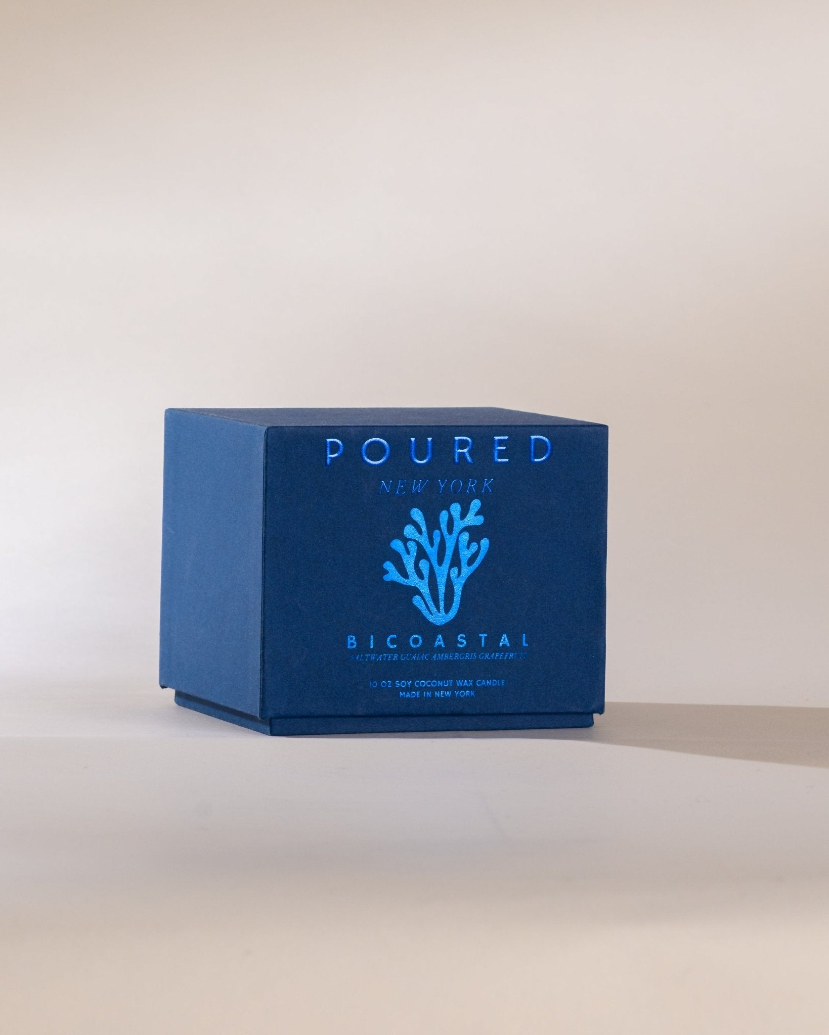 Blue box with 'POURED' and 'BICOASTAL' branding on a beige background