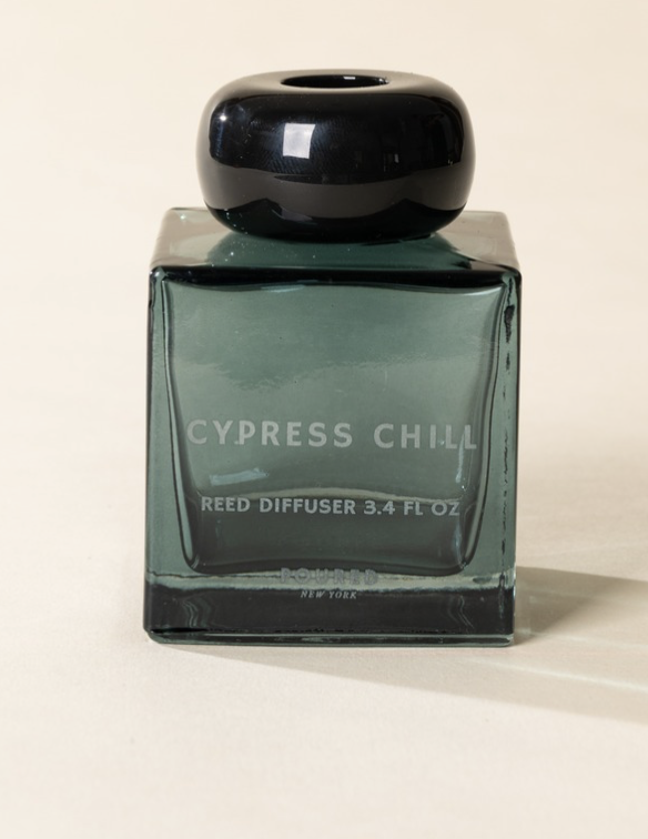 Poured New York 'Cypress Chill' 3.4 fl oz reed diffuser in a teal glass vessel on a neutral background