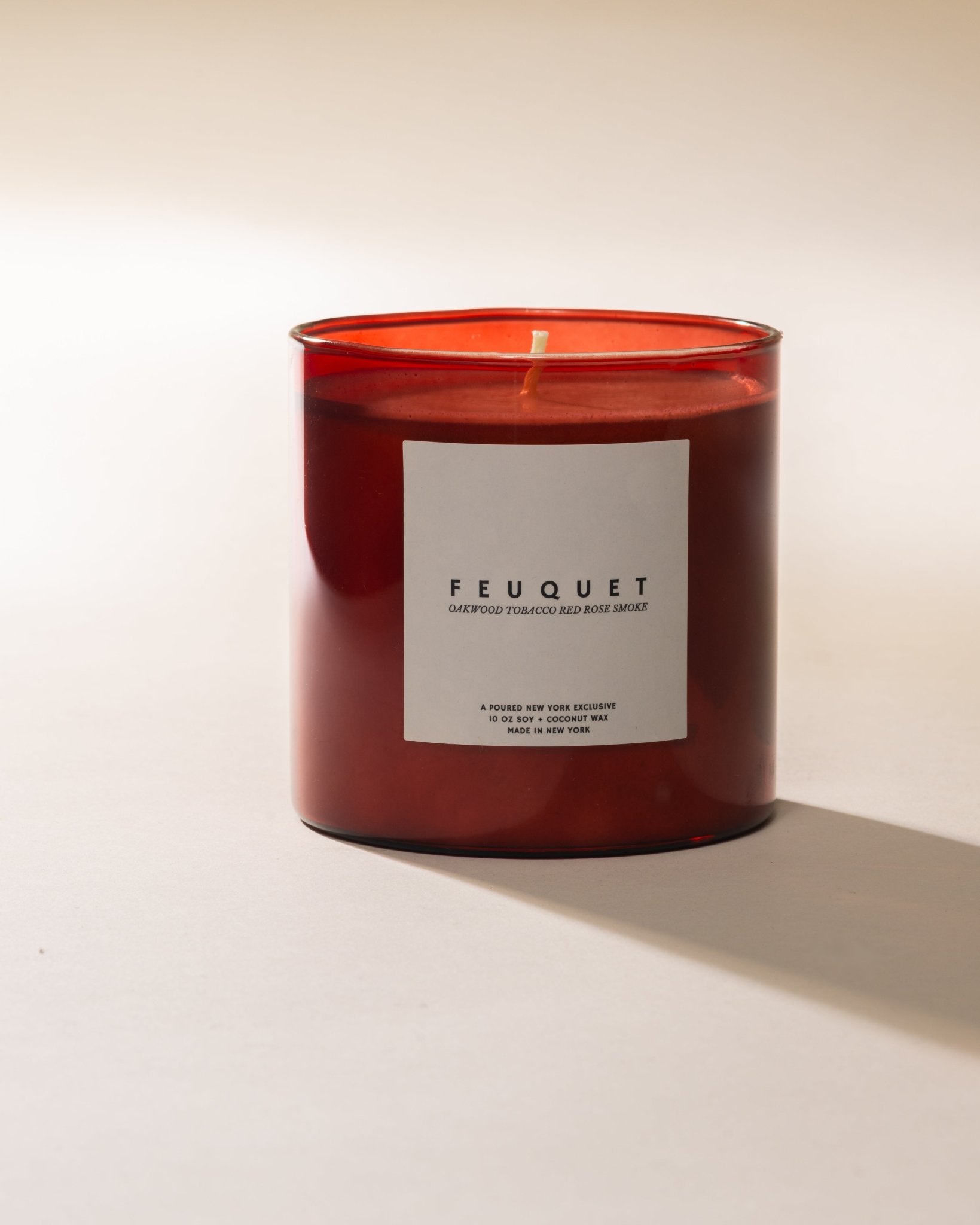 Poured New York ' Feuquet' red candle on a neutral background