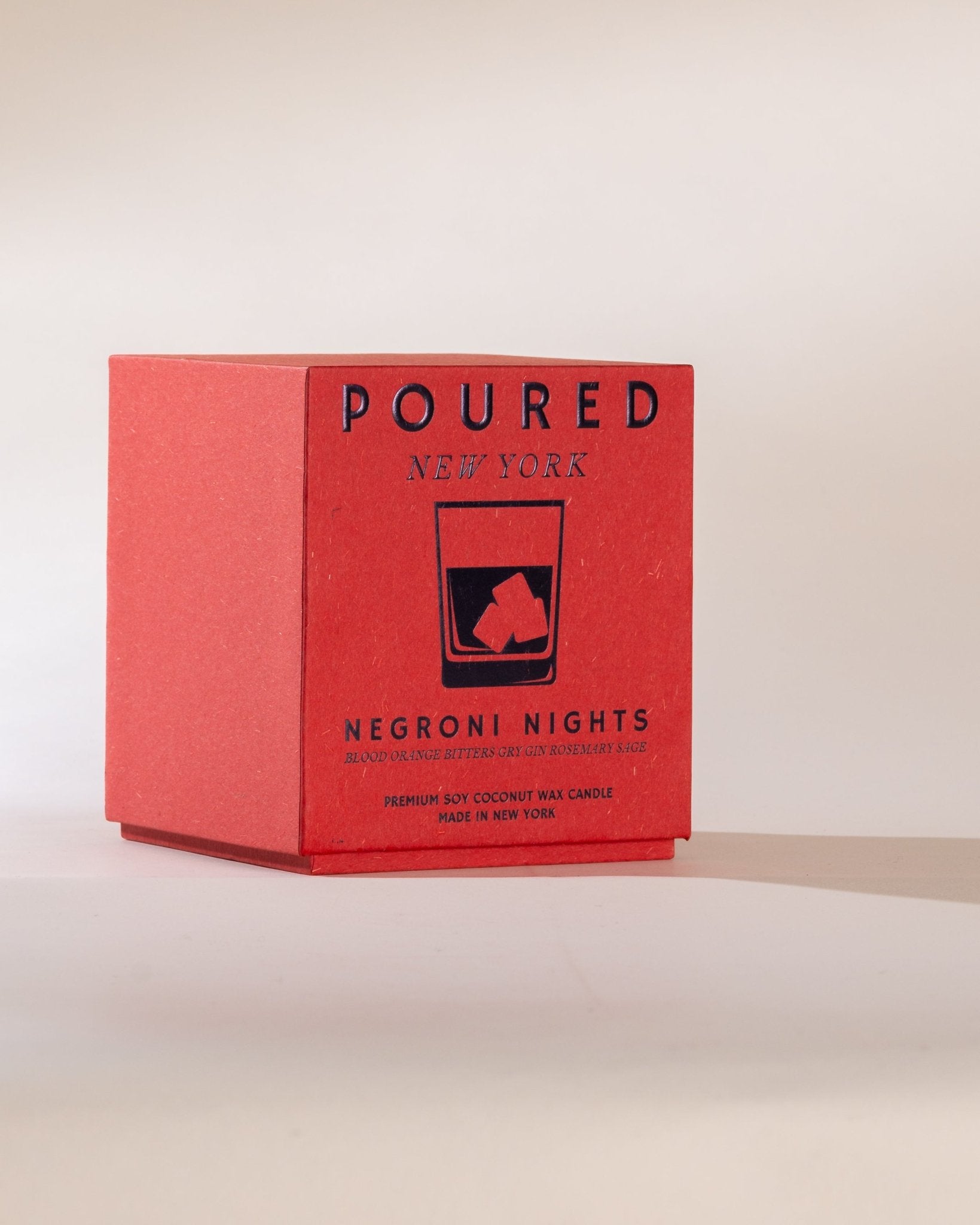 Poured New York 'Negroni Nights' two wick candle box with a negroni glass decal on a neutral background.