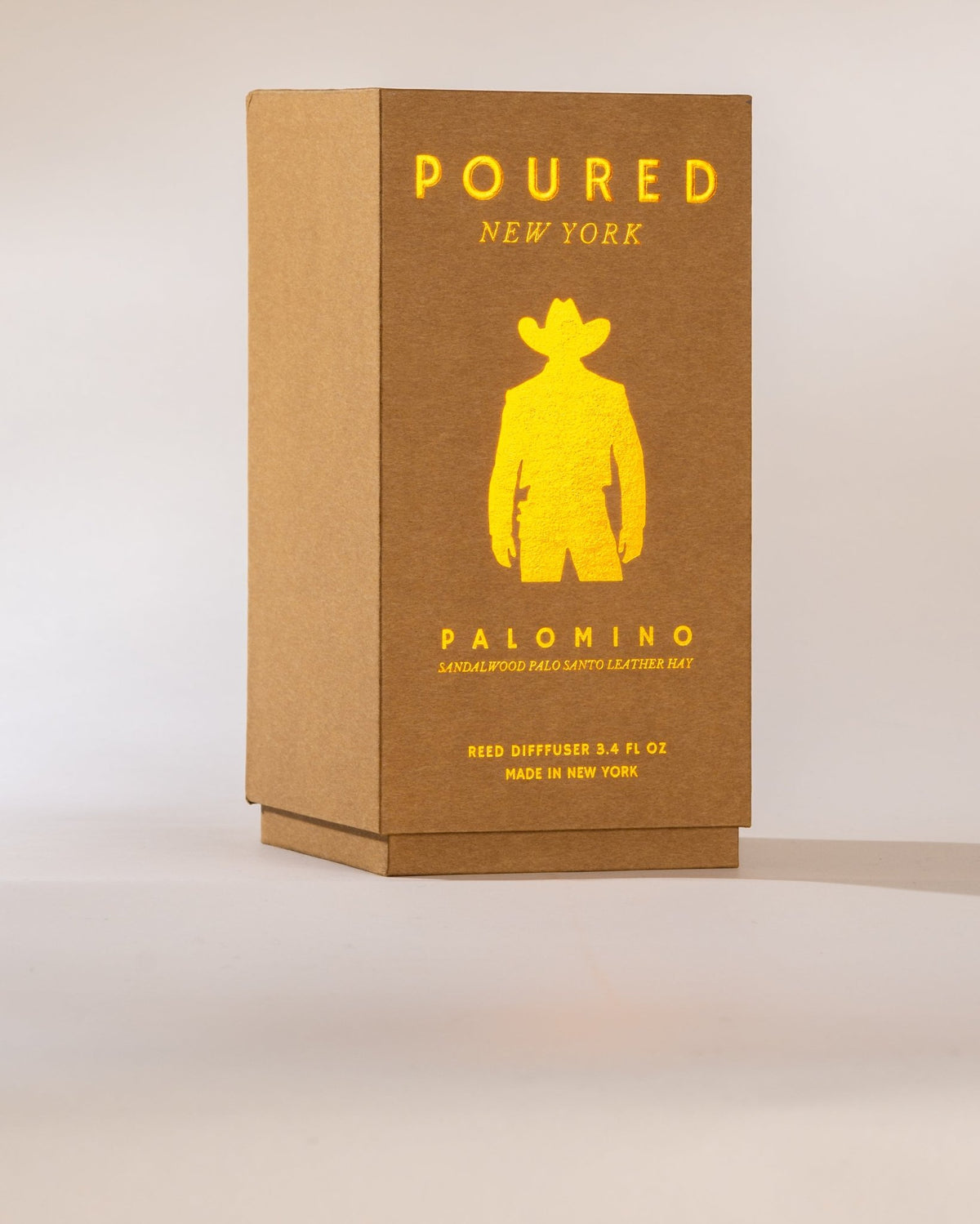 Poured New York 'Palomino' reed diffuser box with a cowboy icon on a neutral background