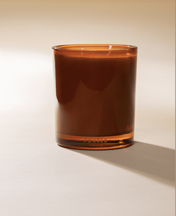 Poured New York 'Palomino' Two Wick candle in a cognac color on a neutral background
