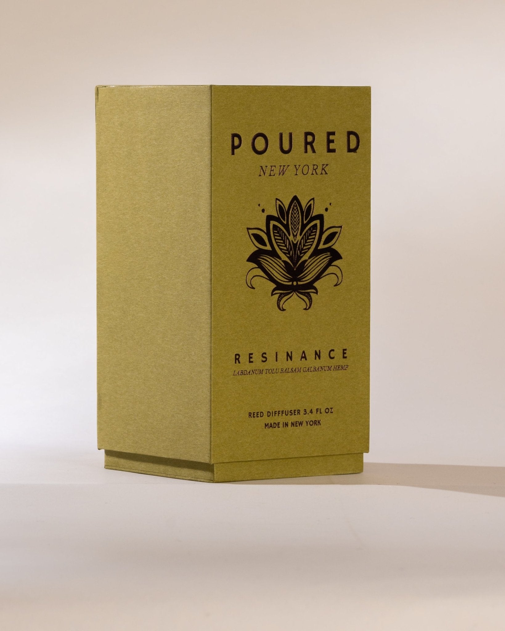 Poured New York 'Resinance' sage green diffuser box with floral decal on neutral background.
