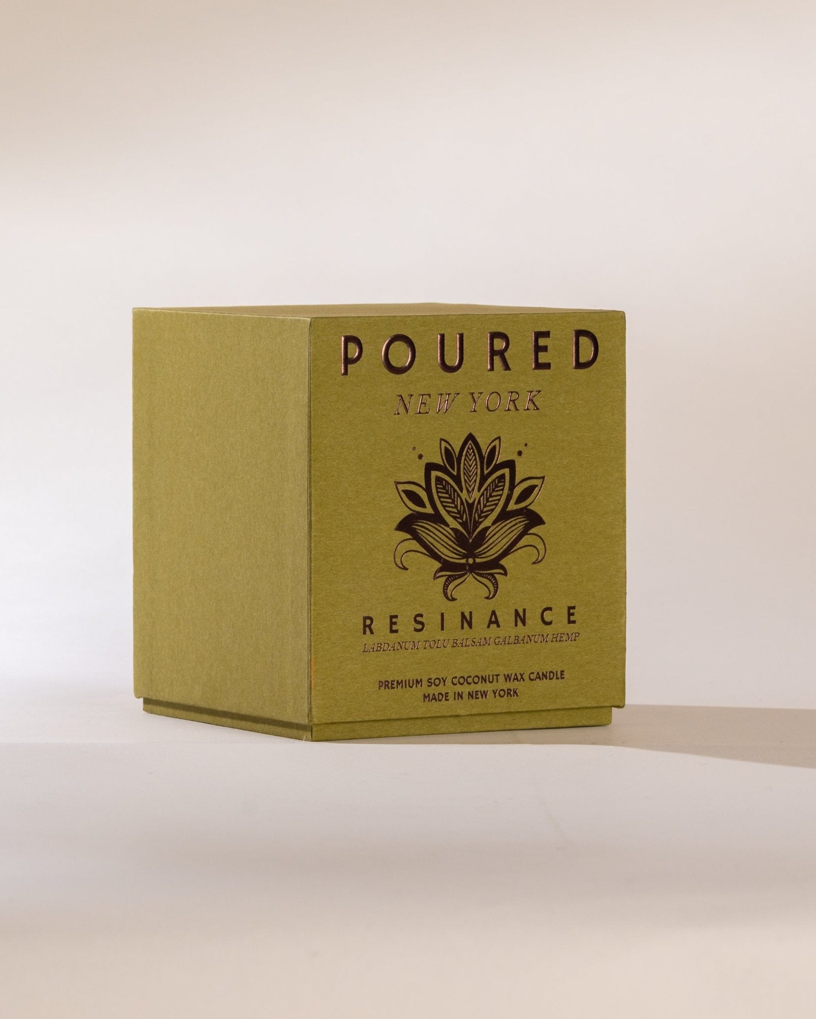 Box of 'POURED NEW YORK' Resinance candle on a beige background