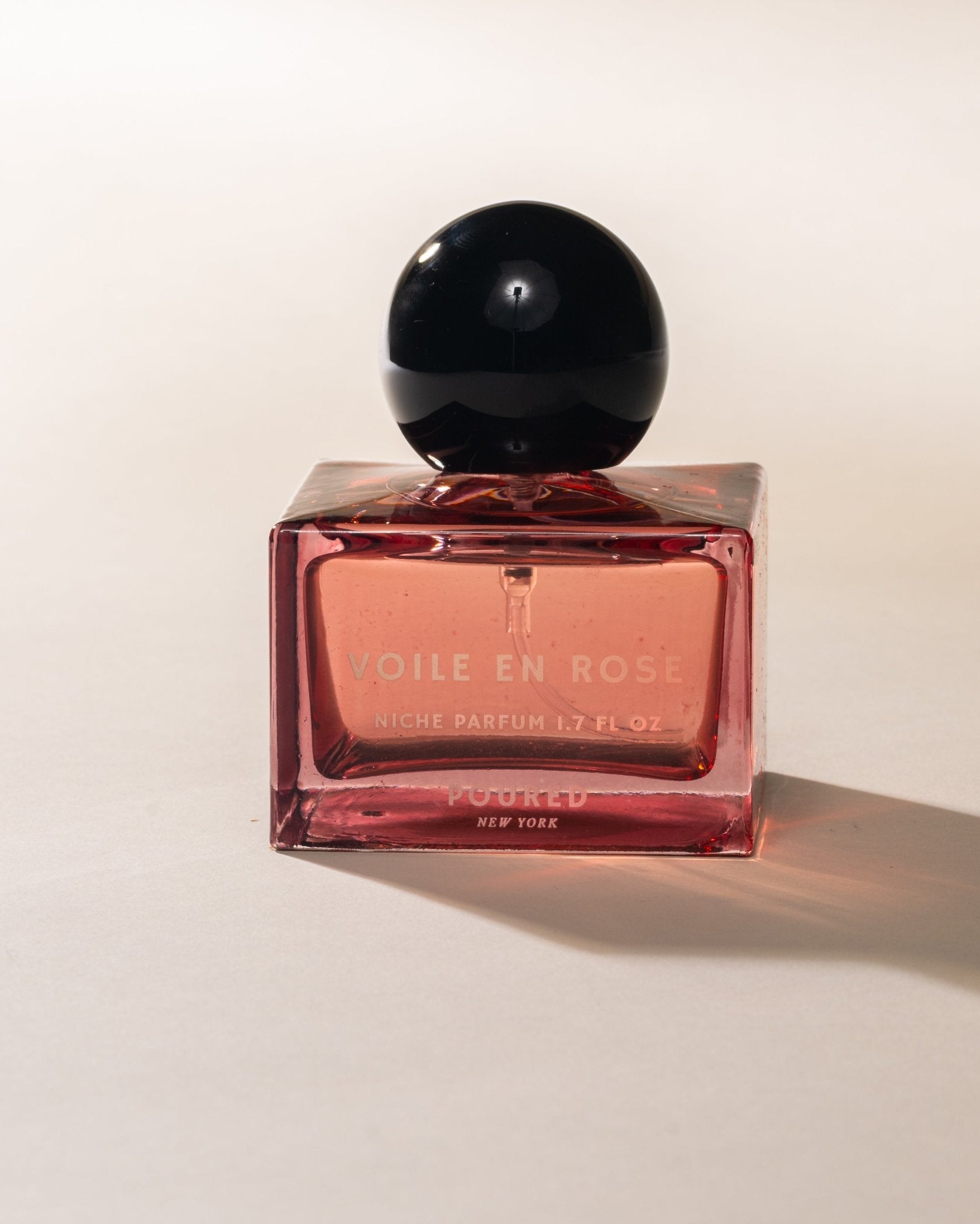 Poured New York 'Voile en Rose' pink niche parfum square bottle on neutral background