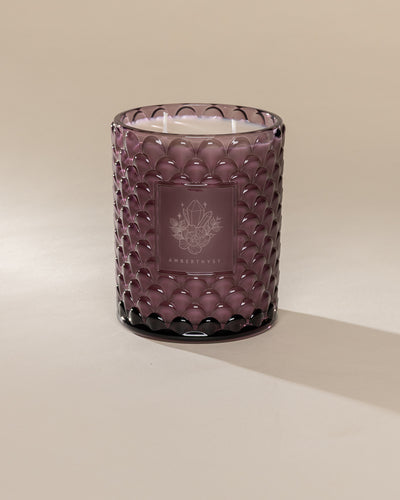 Poured New York 'Amberthyst' 22 oz purple glass vintage etched double wick candle on a neutral background