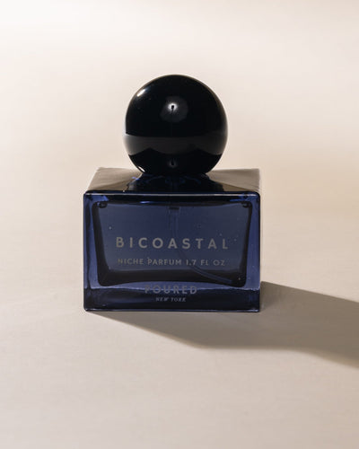 Blue Bicoastal perfume bottle on a beige background