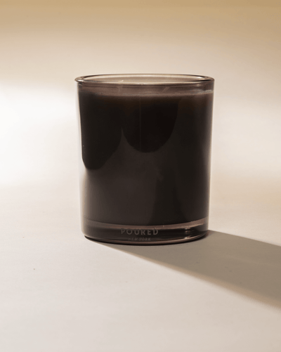 Poured New York 'Bougie D'oud' two wick grey candle on a neutral background.