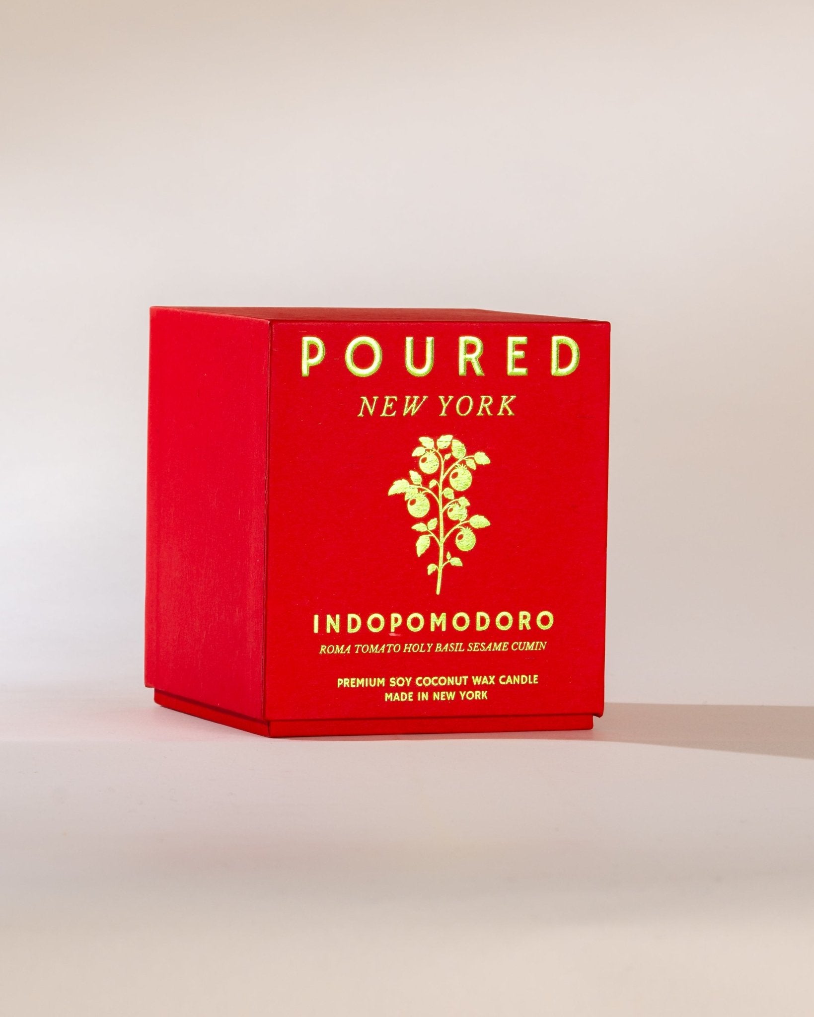 Poured New York 'Indopomodoro' tomato red two wick candle box with tomato vine decal on neutral background