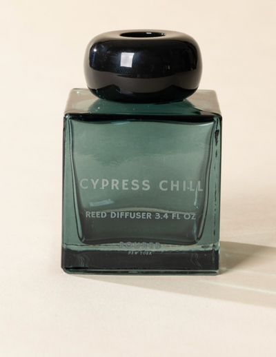 Poured New York 'Cypress Chill' 3.4 fl oz reed diffuser in a teal glass vessel on a neutral background