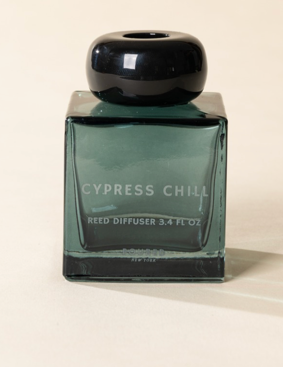 Poured New York 'Cypress Chill' 3.4 fl oz reed diffuser in a teal glass vessel on a neutral background