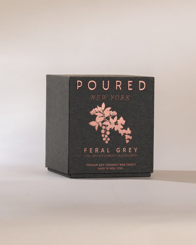 Poured New York 'Feral Grey' grey candle box with an ivy and currant decal on a neutral background.