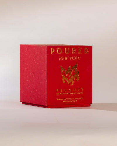 Poured New York ' Feuquet' red candle box with a flame decal on a neutral background