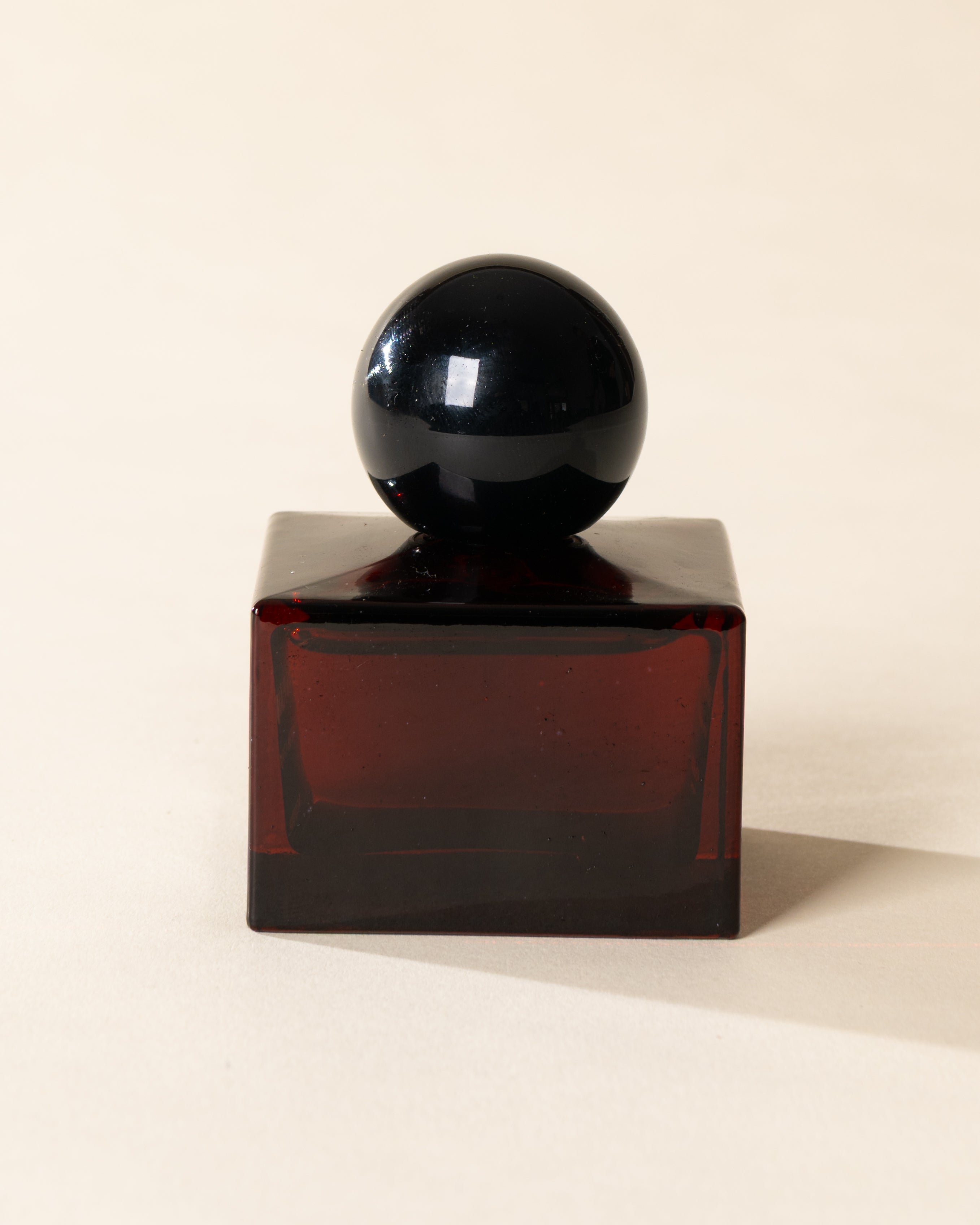 Poured New York 'Flames & Flannel' 1.7 fl oz niche parfum in a red glass bottle on a neutral background