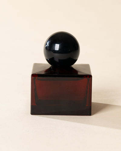 Poured New York 'Flames & Flannel' 1.7 fl oz niche parfum in a red glass bottle on a neutral background