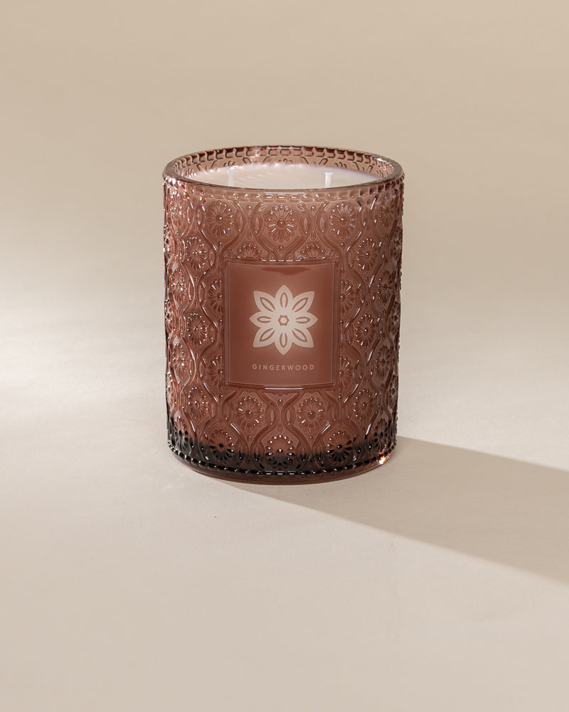 Poured New York 'Gingerwood' brown glass 22 oz double wick candle on a neutral background