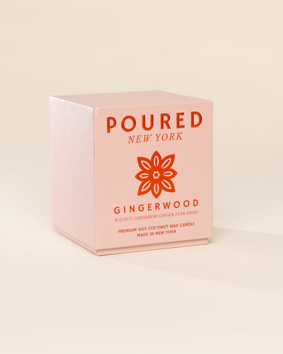 Poured New York 'Gingerwood' candle box packaging on a neutral background