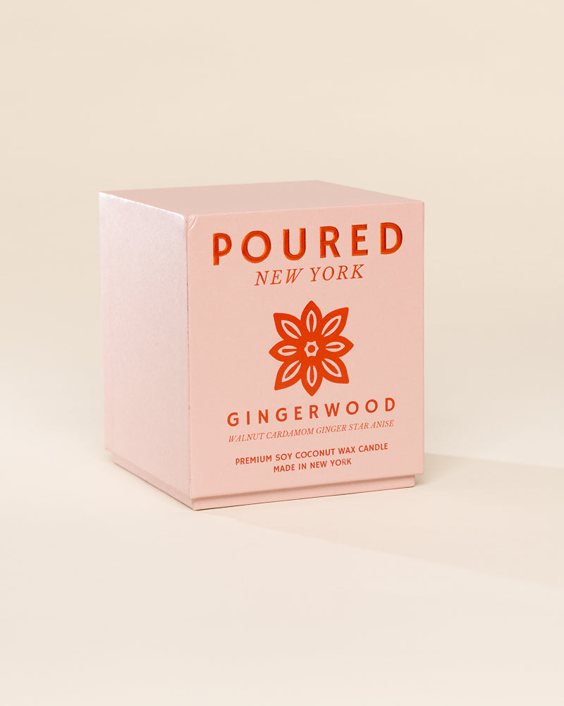 Poured New York 'Gingerwood' candle box packaging on a neutral background