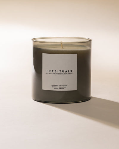 Herbituals candle on a light beige background