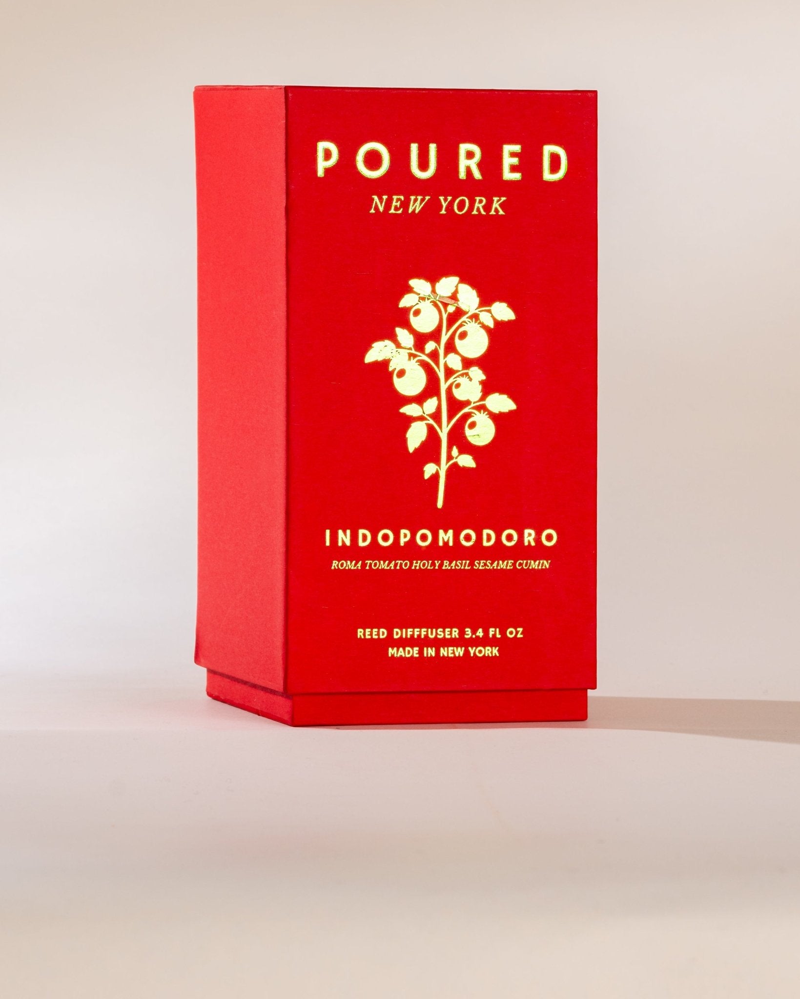 Poured New York 'Indopomodoro' tomato red reed diffuser box with tomato vine decal on neutral background