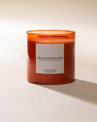 Poured New York 'Indopomodoro' tomato red glass candle on neutral background