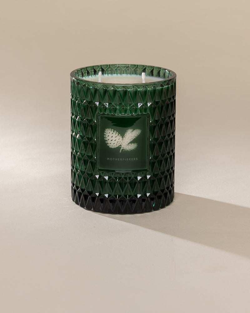 Poured New York 'Motherfirkers' 22 oz green glass vintage etched double wick candle on a neutral background