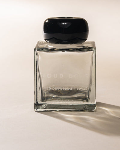 Poured New York 'Noud Bois' Reed Diffuser square bottle with black circular cap on neutral background