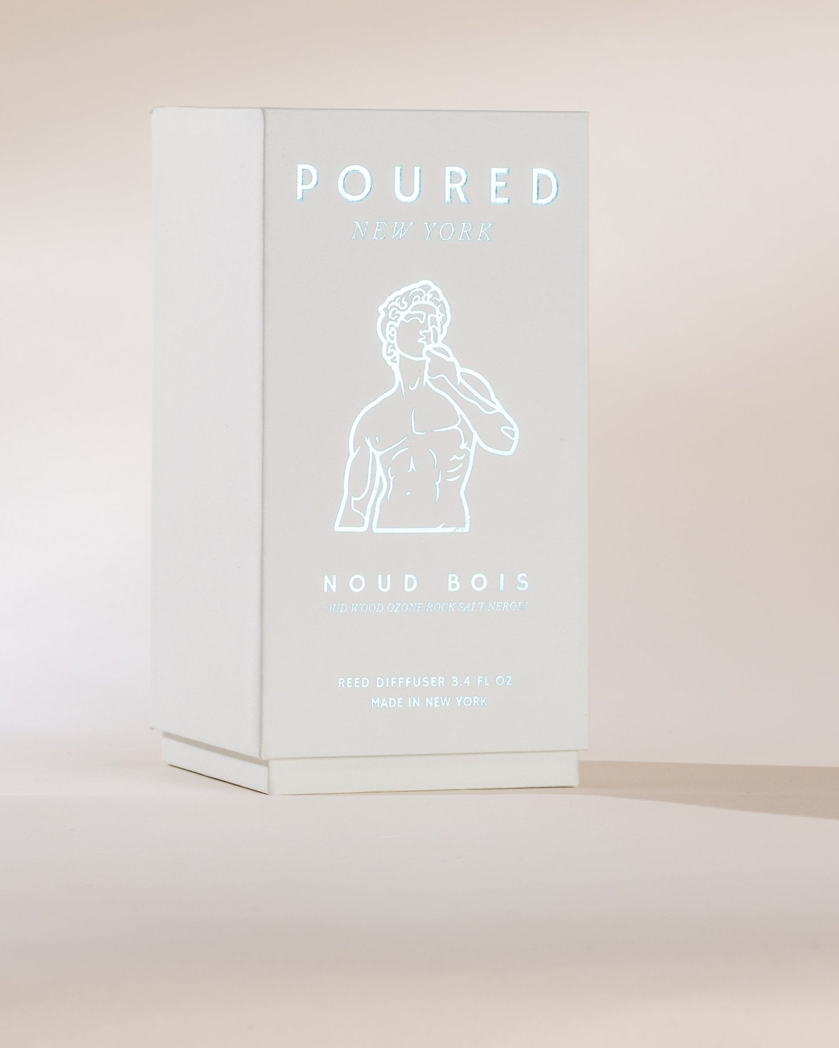 Product packaging with 'POURED' and 'NOUD BOIS' text on a light background