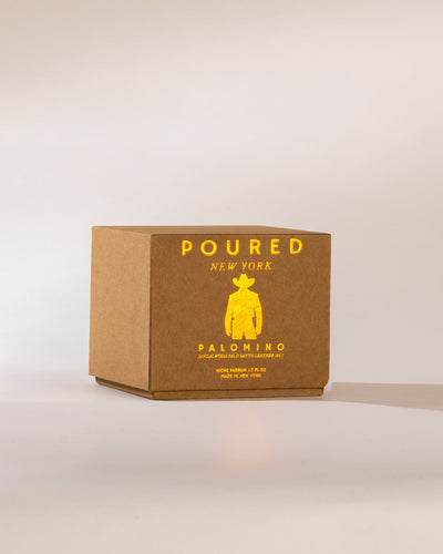 Brown box with gold foil text and cowboy logo on a neutral background