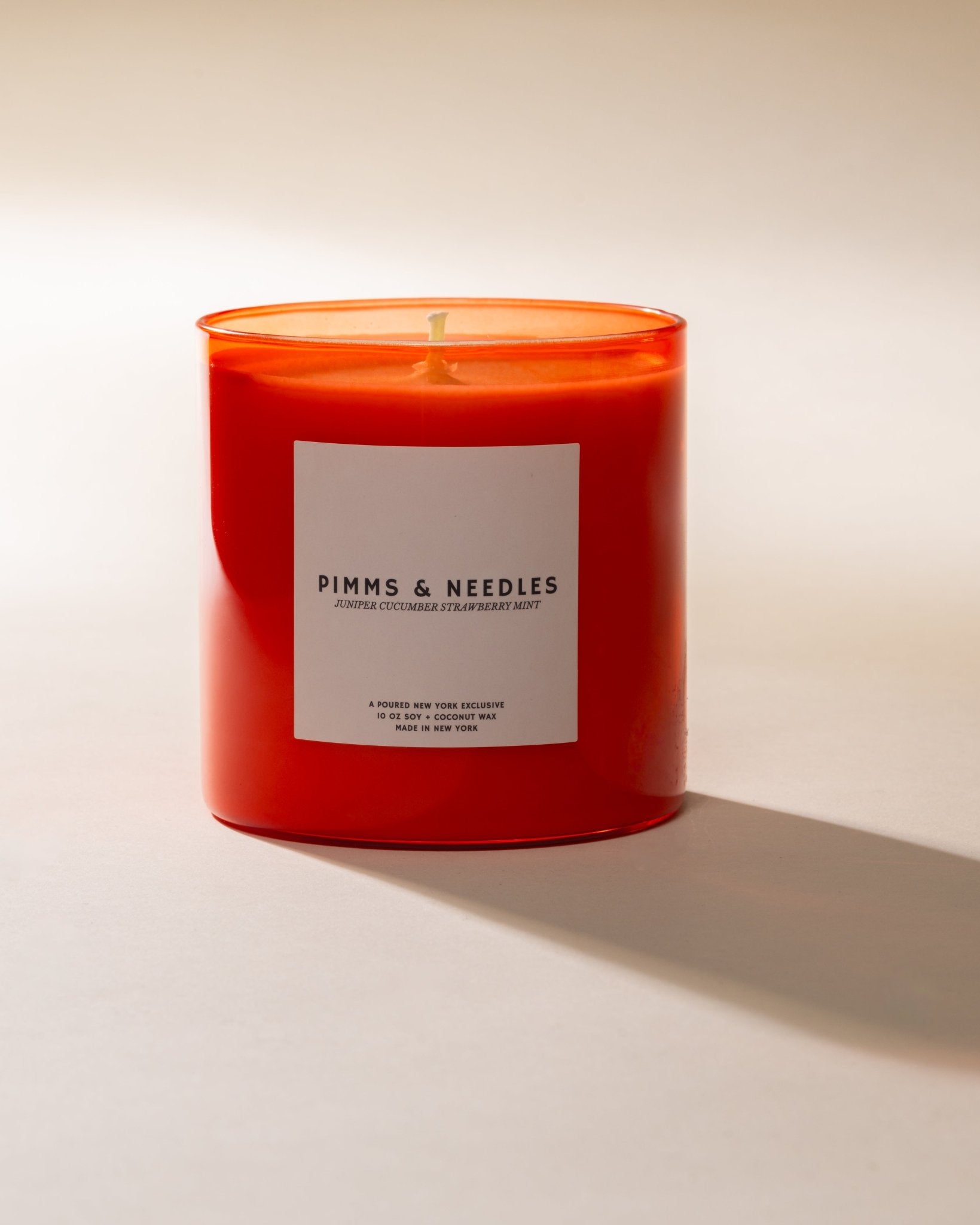 Poured New York 'Pimms & Needles' red candle on a neutral background