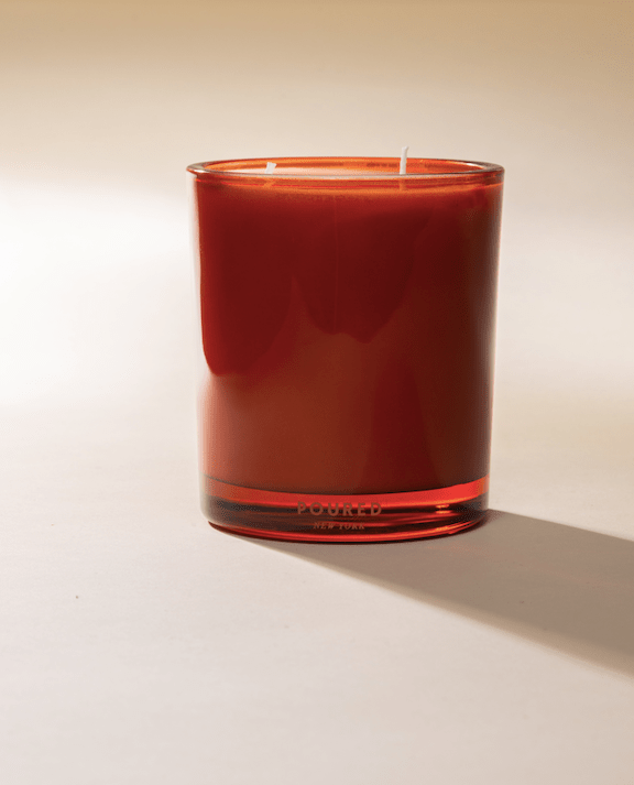Poured New York 'Pimms & Needles' red two wick candle on a neutral background