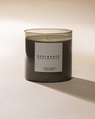 Poured New York 'Resinance' sage green candle on neutral background.