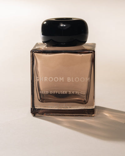 Shroom Bloom reed diffuser bottle on a white background