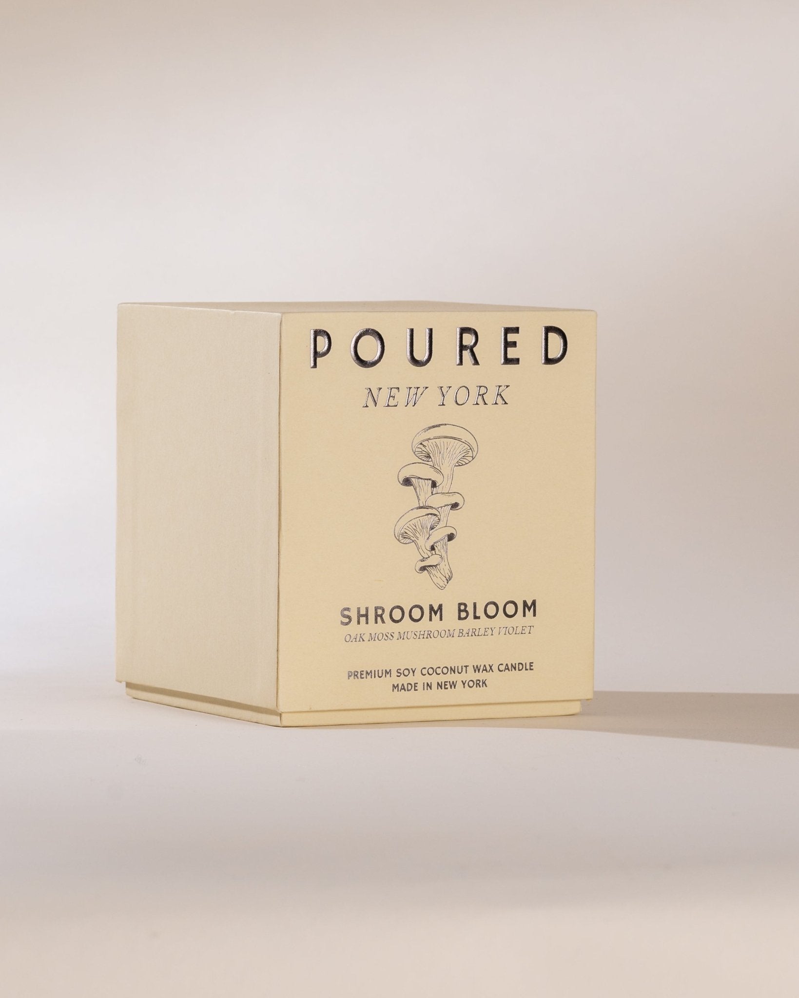 Candle packaging with 'POURED NEW YORK' branding on a light background