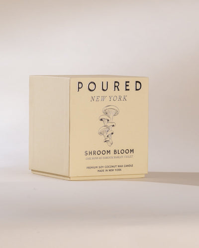 Candle packaging with 'POURED NEW YORK' branding on a light background