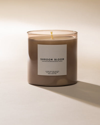 Poured New York 'Shroom Bloom' candle with a label on a beige background
