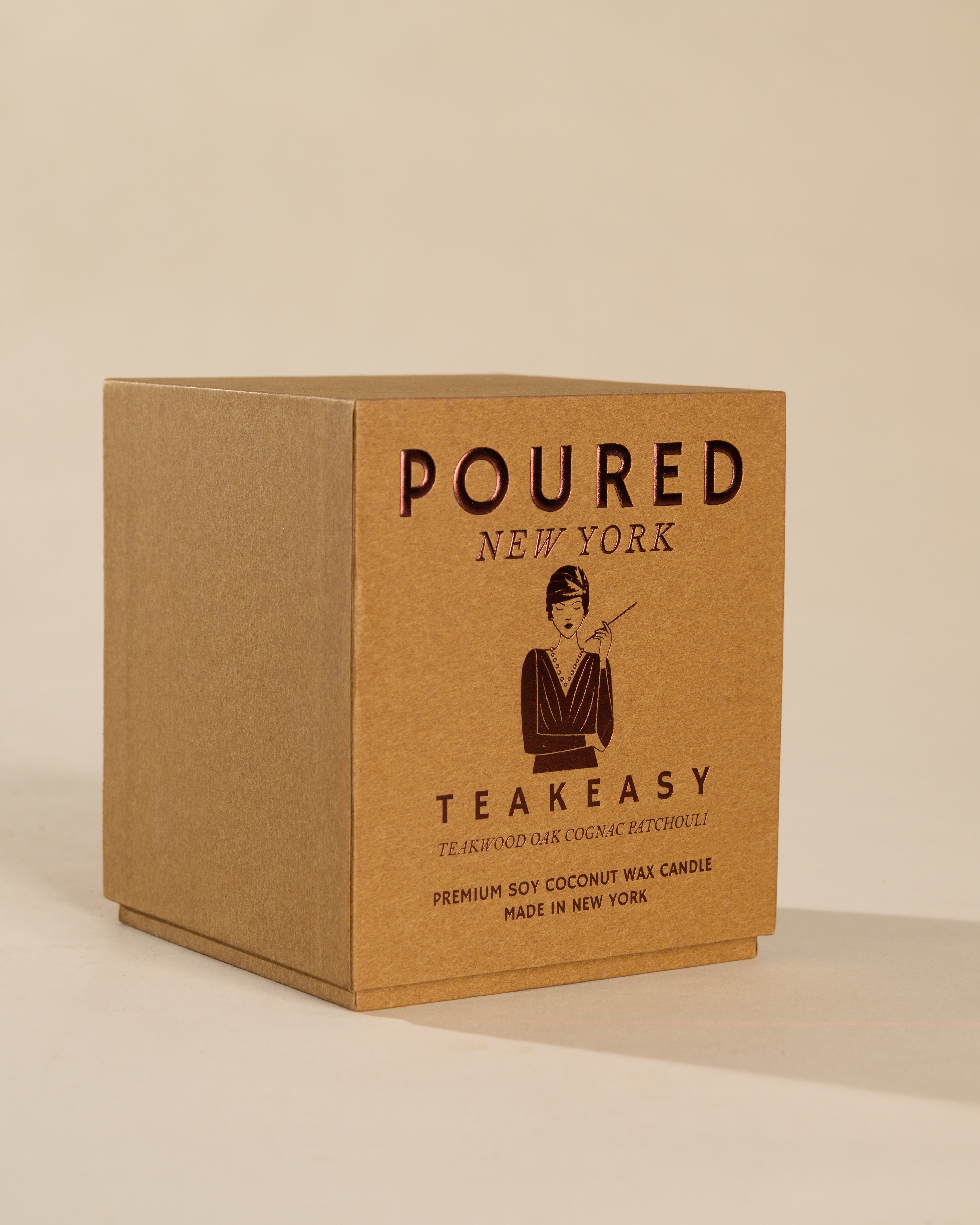 Poured New York 'Teakeasy' candle box packaging on a neutral background