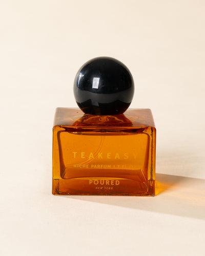 Poured New York 'Teakeasy' 1.7 fl oz niche parfum in an amber glass bottle on a neutral background