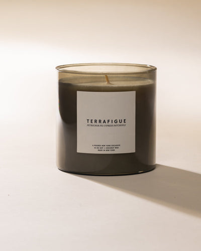 Poured New York 'Terrafigue' olive green candle on a light background