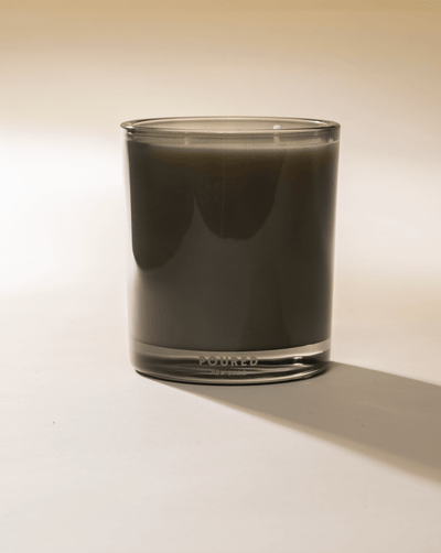 Poured New York 'Terrafigue' two wick olive green candle on a light background