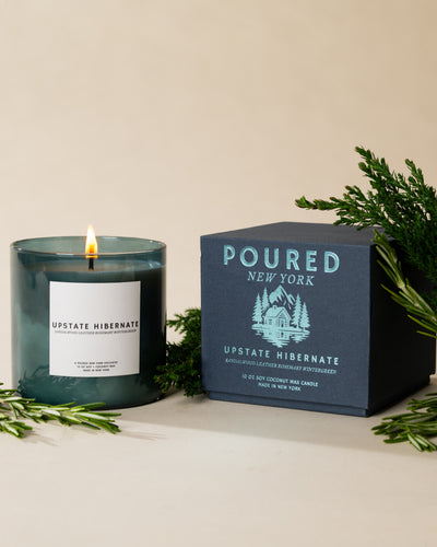 Poured New York 'Upstate Hibernate' soy coconut wax candle with its packaging box on a neutral background