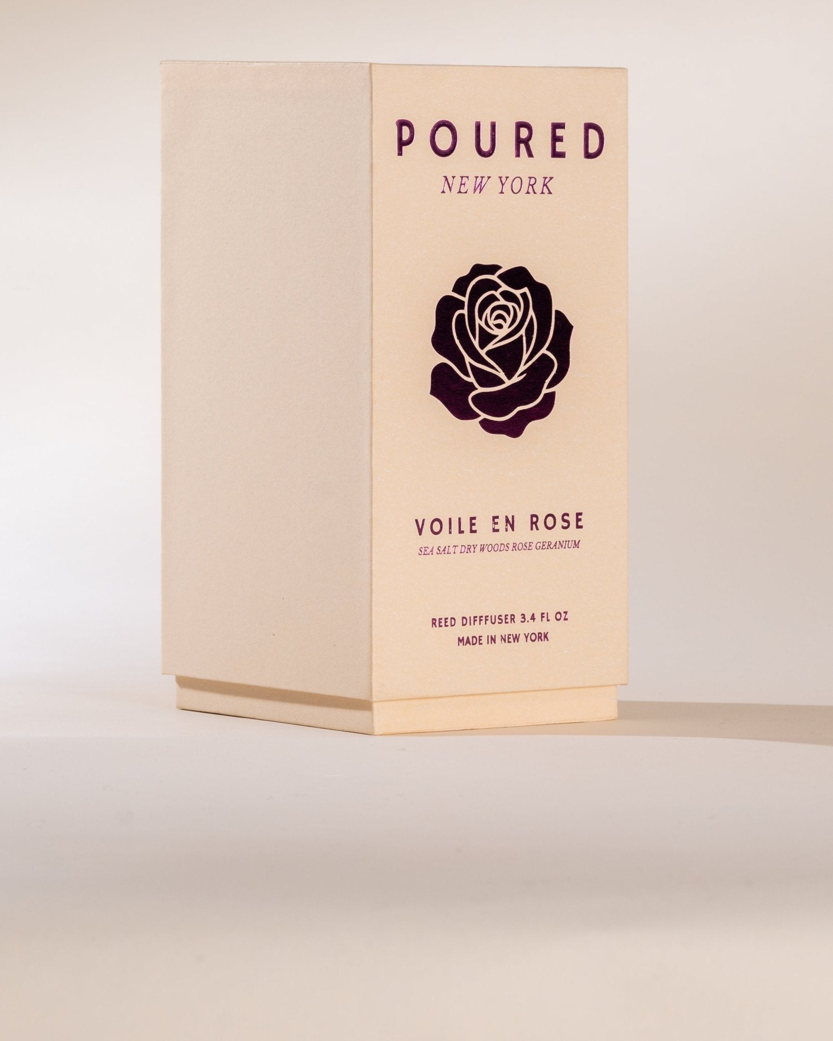 Box of 'Poured New York' Voile en Rose reed diffuser on a light background