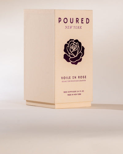Box of 'Poured New York' Voile en Rose reed diffuser on a light background