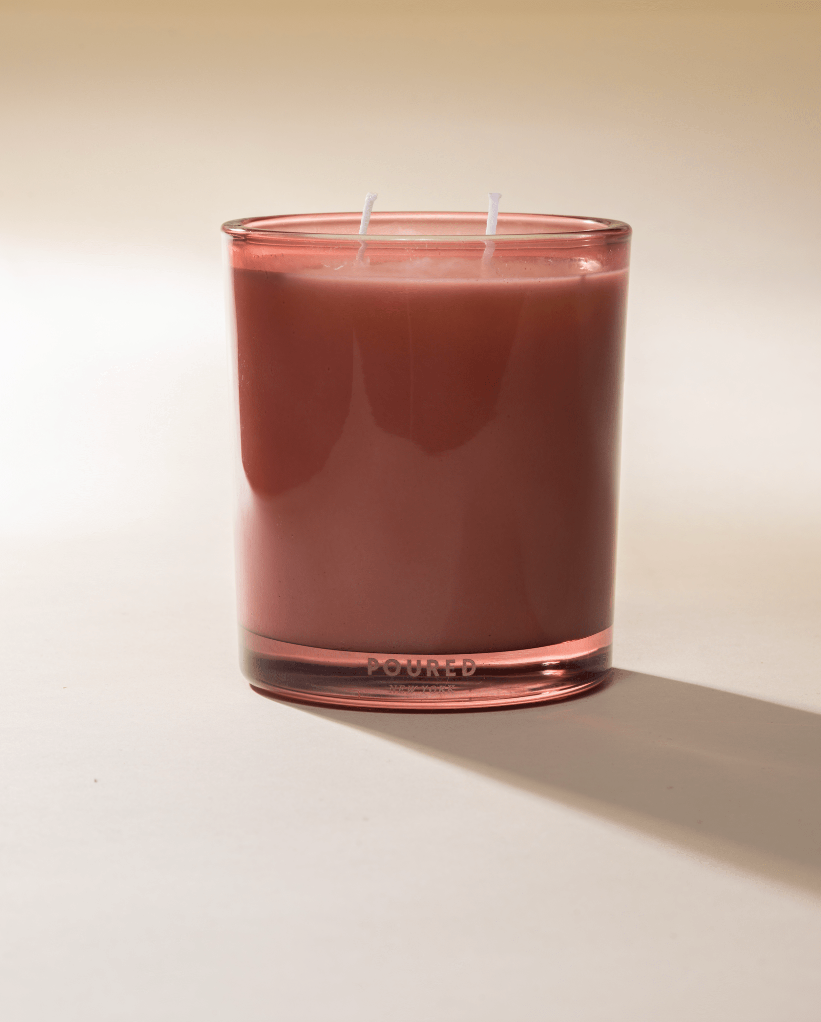 Poured New York 'Voile en Rose' pink two wick glass candle on neutral background